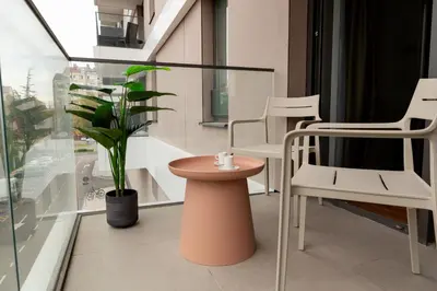 a room with chairs and a table and a plant at Planet Gemini Residence & SPA in Niš