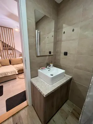 a bathroom with a sink and a mirror at Apartman PETKOVIĆ NLux 110 Milmari resort in Kopaonik