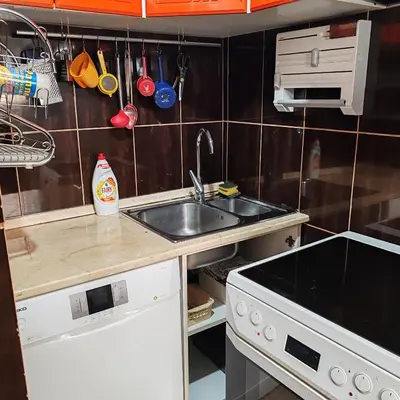a small kitchen with a sink and a stove at Merak stan na dan in Vranje