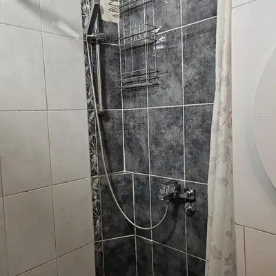 a shower with a hose in a bathroom at Merak stan na dan in Vranje