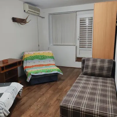 a room with a bed and a couch and a chair at Merak stan na dan in Vranje