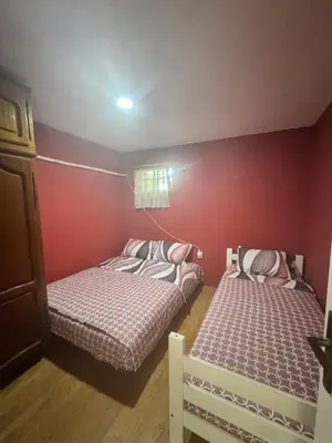 two beds in a small room with red walls at Bovanska Oaza 2 - Bovansko jezero in Aleksinac