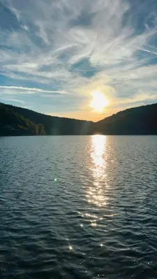 a large body of water with the sun setting at Bovanska Oaza 2 - Bovansko jezero in Aleksinac