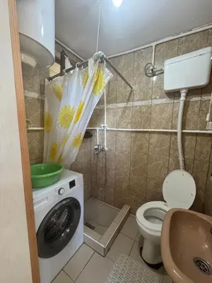 a bathroom with a washing machine and a toilet at Bovanska Oaza 2 - Bovansko jezero in Aleksinac