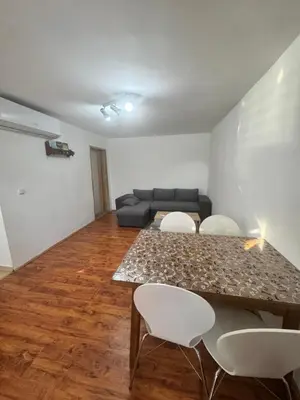 a living room with a table and chairs and a couch at Bovanska Oaza 2 - Bovansko jezero in Aleksinac
