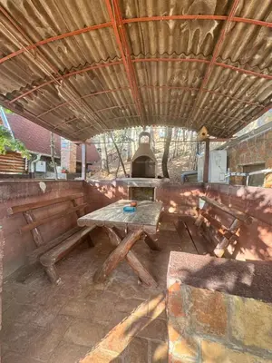 an outdoor kitchen with a table and a grill at Bovanska Oaza 2 - Bovansko jezero in Aleksinac