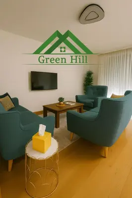 a living room with blue chairs and a green hill sign at Luxury Stay in Vrnjačka Banja C1 in Vrnjačka Banja