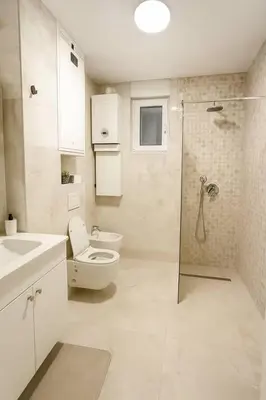 a white bathroom with a toilet and a shower at Luxury Stay in Vrnjačka Banja C1 in Vrnjačka Banja
