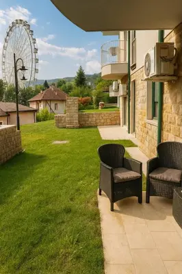 a patio with two chairs and a ferris wheel at Luxury Stay in Vrnjačka Banja C1 in Vrnjačka Banja