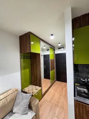 a living room with a couch and a mirror at Apartman Mist C113 - Bela Reka in Brzeće
