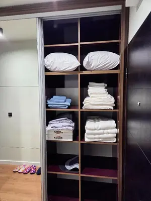 a closet filled with lots of shirts and pillows at Apartman Mist C113 - Bela Reka in Brzeće