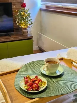a plate of food and a cup of coffee on a table at Apartman Mist C113 - Bela Reka in Brzeće