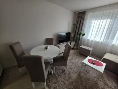 a living room with a white table and chairs at Apartman Bibi centar in Niš
