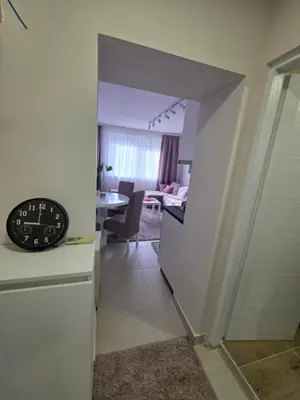 a clock sitting on top of a counter in a room at Apartman Bibi centar in Niš