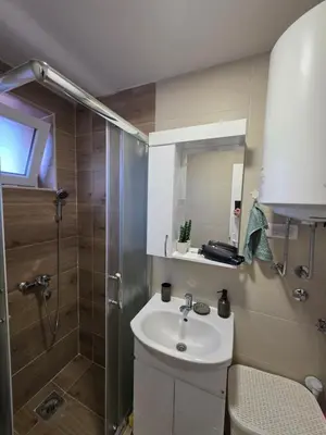 a bathroom with a sink and a shower at Apartman Bibi centar in Niš