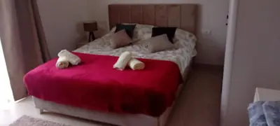 a bedroom with a bed with two towels on it at Apartman Bibi centar in Niš