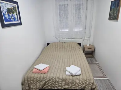 a bedroom with a bed with two pillows on it at City Comfort Suite in Paraćin
