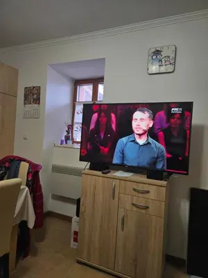 a flat screen tv sitting on top of a wooden cabinet at Apartman Vila Mir in Vrnjačka Banja