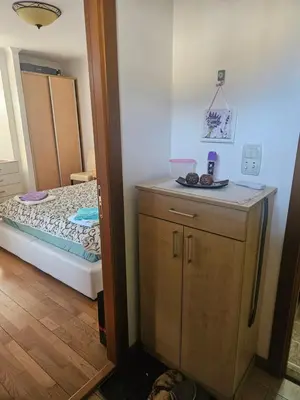 a small room with a bed and a small cabinet at Apartman Vila Mir in Vrnjačka Banja