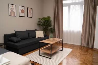 a living room with a couch and a table at Millenium Apartments City Center in Niš