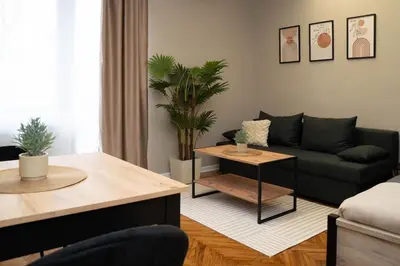 a living room with a couch and a table at Millenium Apartments City Center in Niš