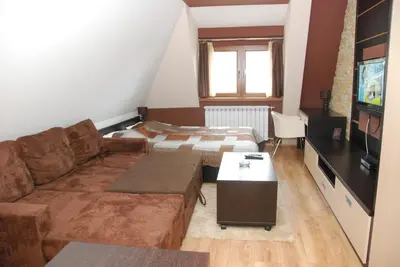 a living room with a couch and a bed at Ski & Relax Apartment in Kopaonik