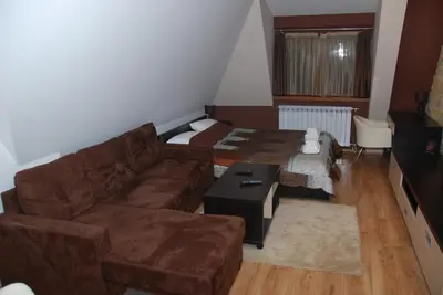 a living room with a couch and a table at Ski & Relax Apartment in Kopaonik
