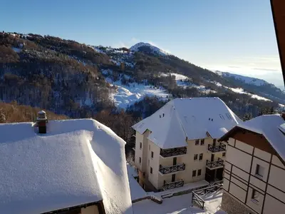 an aerial view of a building in the snow at Ski & Relax Apartment in Kopaonik