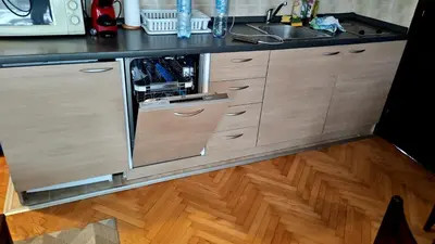 an open cabinet in a kitchen with a sink at Vila Gorica - Planinska kuca in Kopaonik
