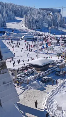 a group of people in the snow on a ski slope at Vila Gorica - Planinska kuca in Kopaonik