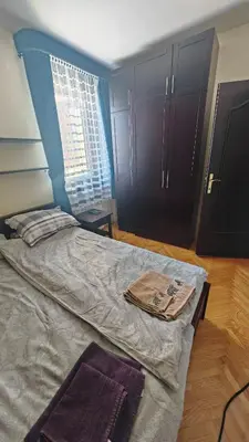a bedroom with a large bed with a blue headboard at Vila Gorica - Planinska kuca in Kopaonik