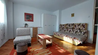 a living room with a couch and a chair at Stan Na Dan Ćuprija in Ćuprija