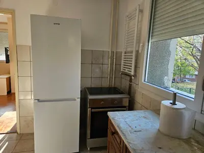 a kitchen with a white refrigerator and a window at DiO in Kruševac