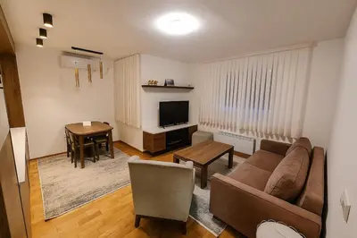 a living room with a couch and a table at Cozy Elegance Apartment D1 in Vrnjačka Banja
