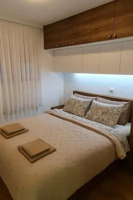 a bedroom with a bed with two towels on it at Cozy Elegance Apartment D1 in Vrnjačka Banja