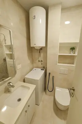 a white bathroom with a toilet and a sink at Cozy Elegance Apartment D1 in Vrnjačka Banja