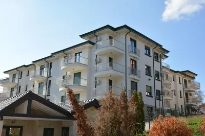 a large white building with balconies on it at Cozy Elegance Apartment D1 in Vrnjačka Banja