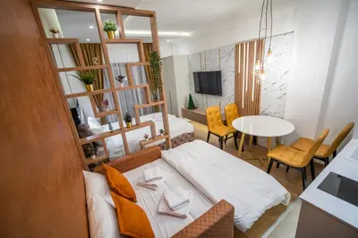 a living room with a bed and a dining room at Pleasure LUX G999 Kopaonik in Kopaonik