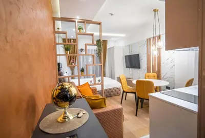 a room with a kitchen and a living room at Pleasure LUX G999 Kopaonik in Kopaonik