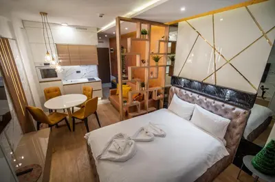 a bedroom with a bed and a table and chairs at Pleasure LUX G999 Kopaonik in Kopaonik