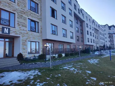 a row of apartment buildings with snow on the ground at Pleasure LUX G999 Kopaonik in Kopaonik