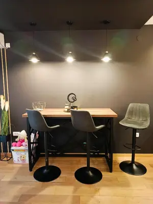 a desk with two chairs and a table with lights at DeLux apartman Eleni rooms in Vrnjačka Banja