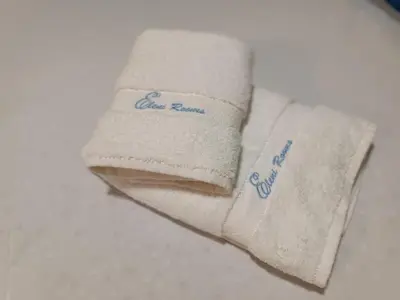 a white towel with the words clint return on it at DeLux apartman Eleni rooms in Vrnjačka Banja