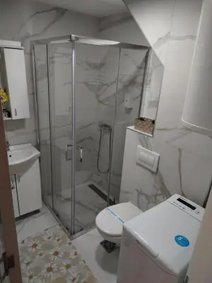 a bathroom with a shower and a toilet and a sink at DeLux apartman Eleni rooms in Vrnjačka Banja