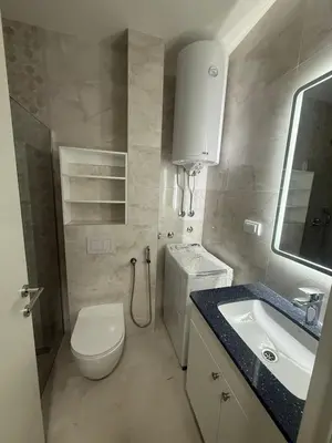 a bathroom with a toilet and a sink at Soft Living Family Suite A6 in Vrnjačka Banja
