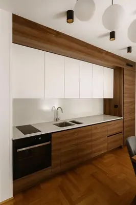 a kitchen with white cabinets and a sink at Soft Living Family Suite A6 in Vrnjačka Banja