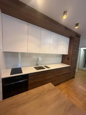 a kitchen with white cabinets and a sink at Soft Living Family Suite A6 in Vrnjačka Banja