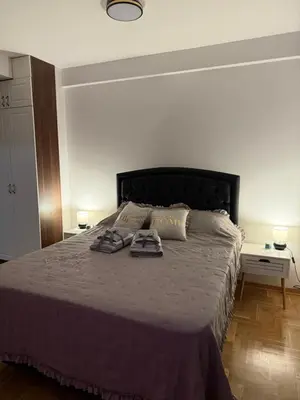 a bedroom with a bed with two towels on it at Apartman Banjac in Vrnjačka Banja