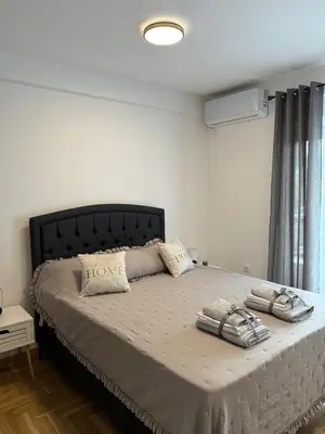 a bedroom with a large bed with two pillows on it at Apartman Banjac in Vrnjačka Banja