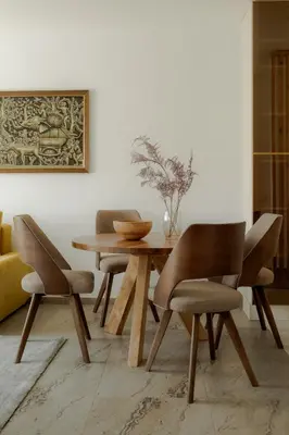 a dining room with a wooden table and chairs at LALA & DAUGHTERS Apartment in Vrnjačka Banja